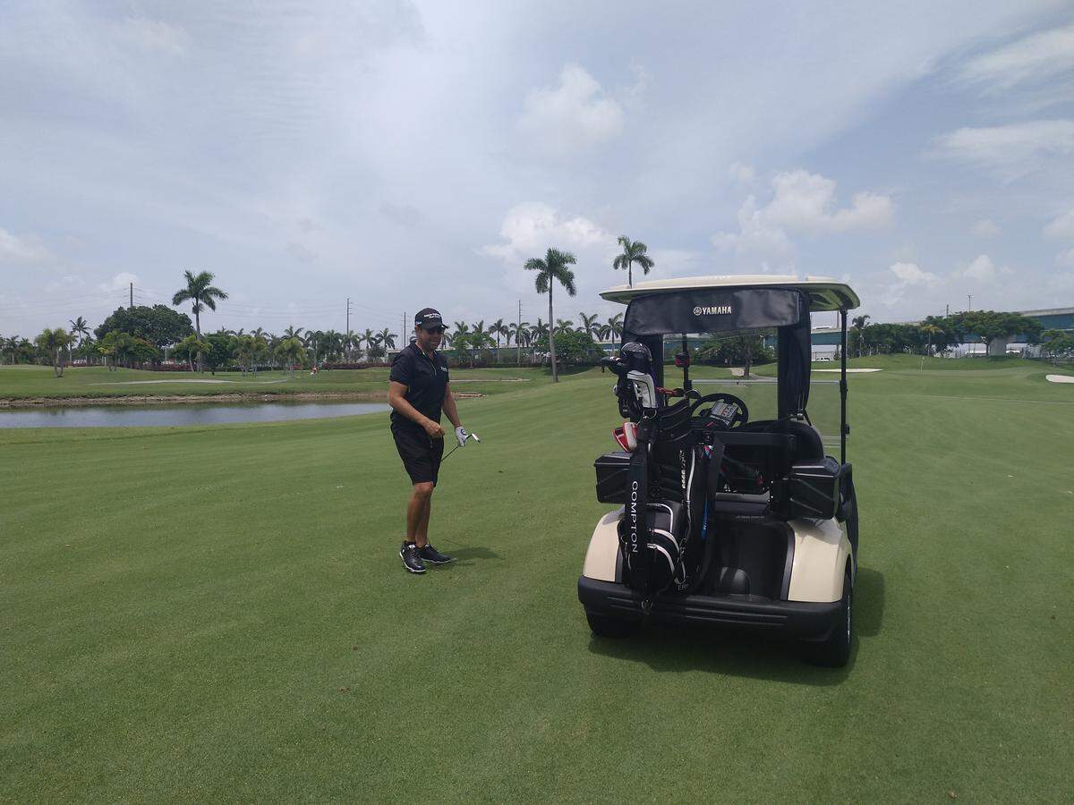 Professional golfer Erik Compton walks back to his golf cart at Melreese Country Club on July 17, 2018.