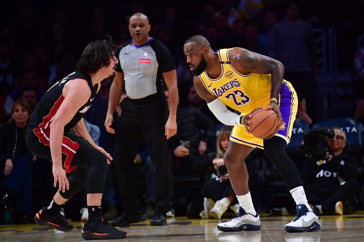 El jugador de los Lakers LeBron James (der.) trata de pasar la marca de Jaime Jáquez Jr., del Heat de Miami, en el partido celebrado el 15 de enero de 2025 en Los Angeles.