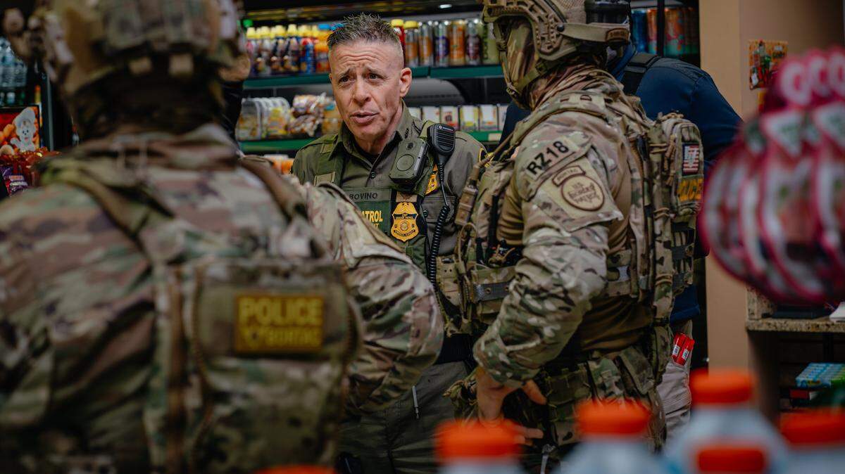 CHICAGO, ILLINOIS - OCTOBER 31: Chief Patrol Agent of the El Centro Sector for U.S. Customs and Border Protection Gregory Bovino talks with other federal agents during a gas station stop to buy snacks and use the restroom while making a series of immigration arrests on the far north side of the city on October 31, 2025, in Chicago, Illinois. The arrests are part of President Donald Trump's administration's "Operation Midway Blitz," an ongoing immigration enforcement surge across the Chicago region. (Photo by Jamie Kelter Davis/Getty Images)