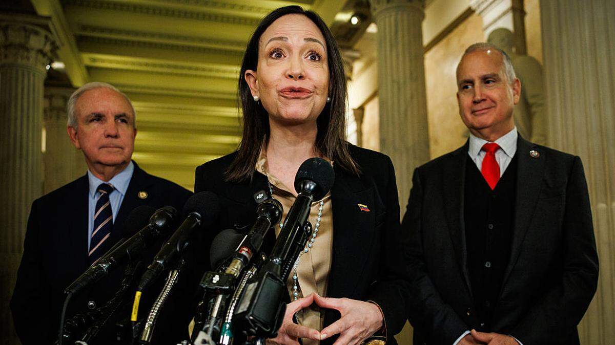 La líder de la oposición venezolana, María Corina Machado, habla con periodistas junto a los congresistas Mario Díaz-Balart (der.) y Carlos Giménez tras una reunión a puerta cerrada con legisladores republicanos en el Capitolio de Estados Unidos, el 20 de enero de 2026 en Washington, DC. 