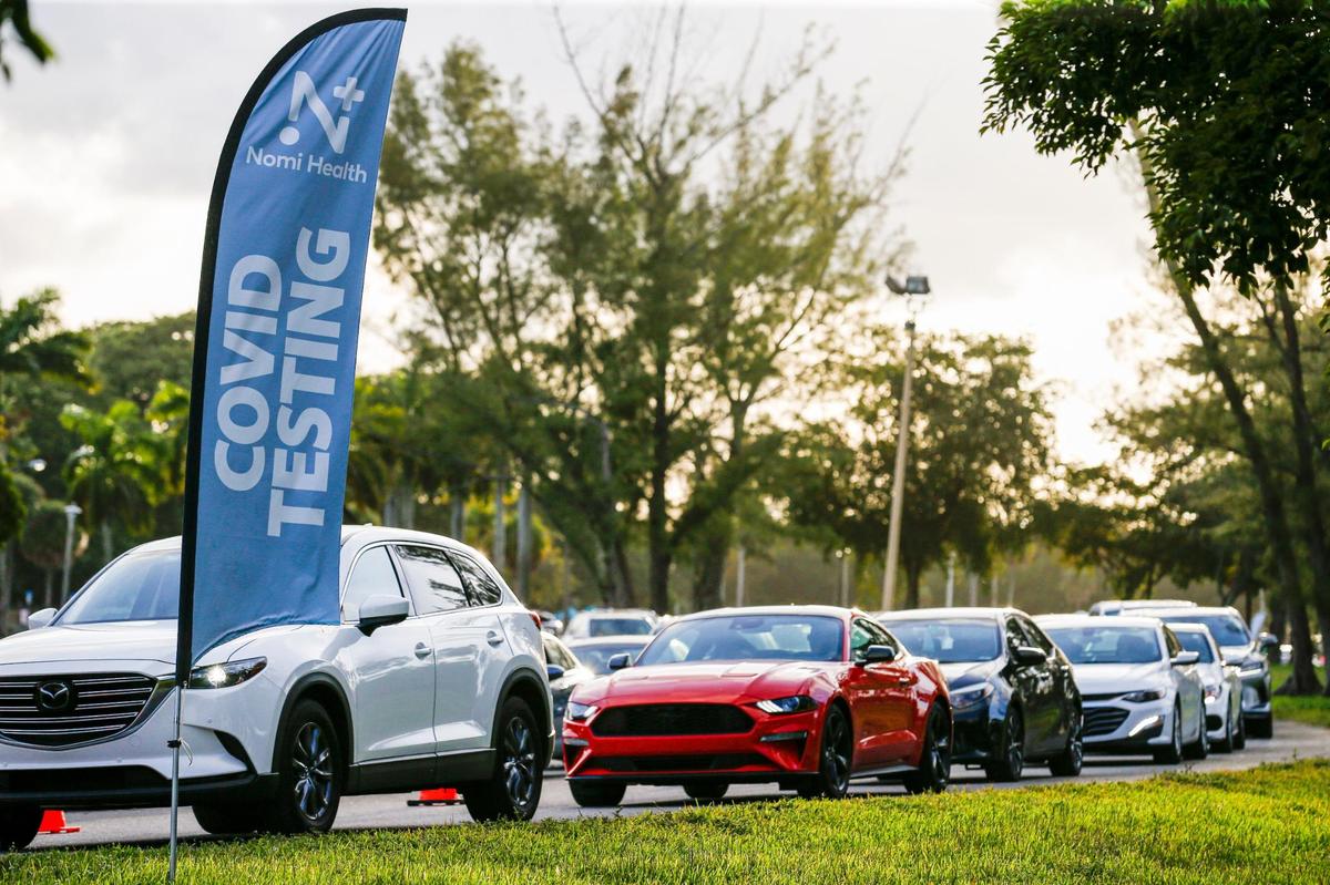 Largas filas de vehículos se forman mientras los automovilistas esperan para hacerse la prueba de COVID-19 en el Tropical Park en Miami, Florida, el viernes 17 de diciembre de 2021.