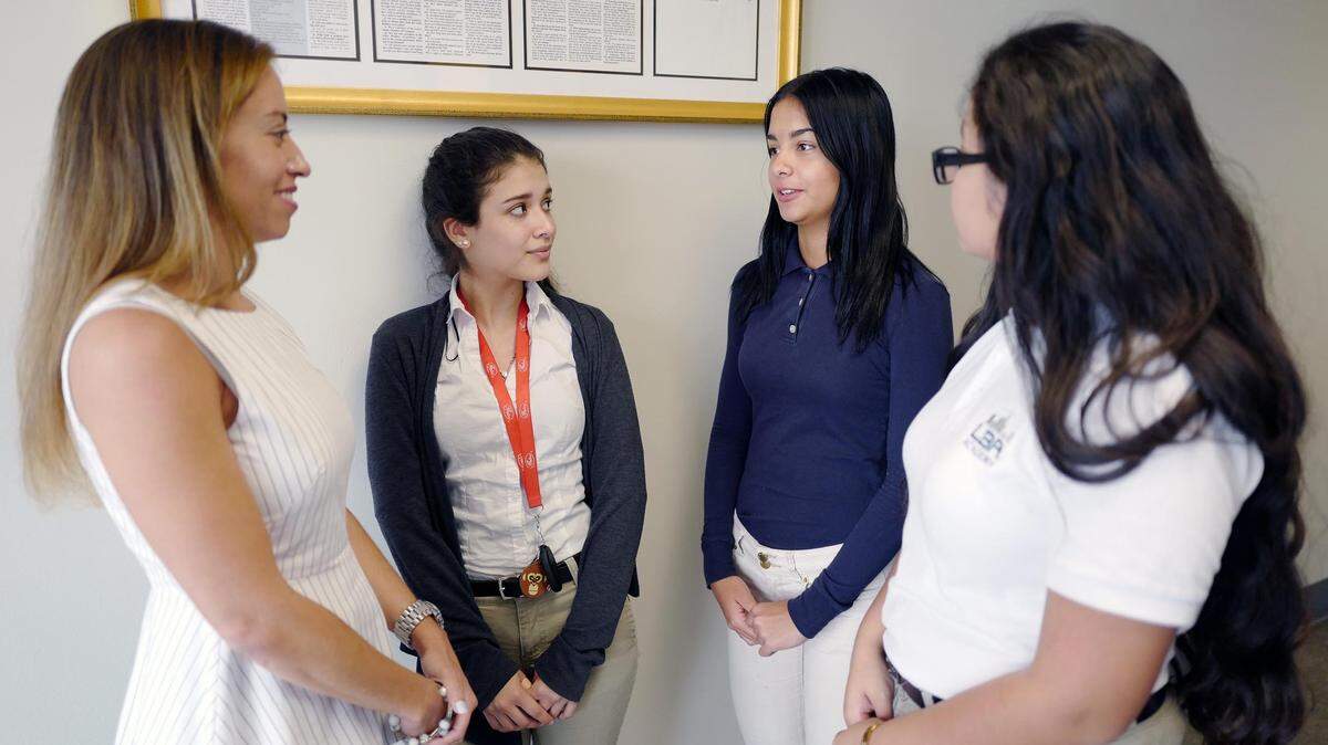 From left, Principal Jennifer Jaynes with students Diana Mogollón, Thalia Caro and Nathalie Orozco at the Latin Builders Association (LBA) Academy in Hialeah Gardens.