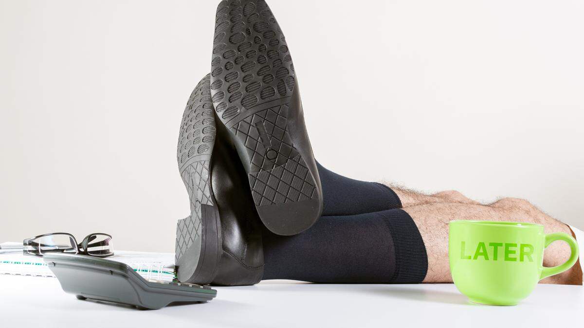 Business man in office relaxing with his legs crossed over desk. Break time, procrastination concept