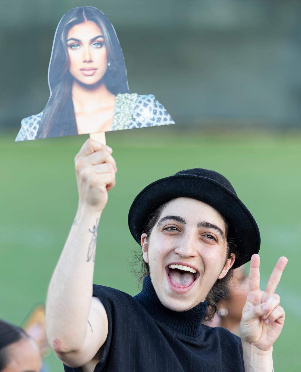 Singer Emily Estefan holds a photo of Lina Luaces during the Miss Universe Cuba 2025 pageant at Milander Park on Tuesday, July 8, 2025, in Hialeah, Fla.
