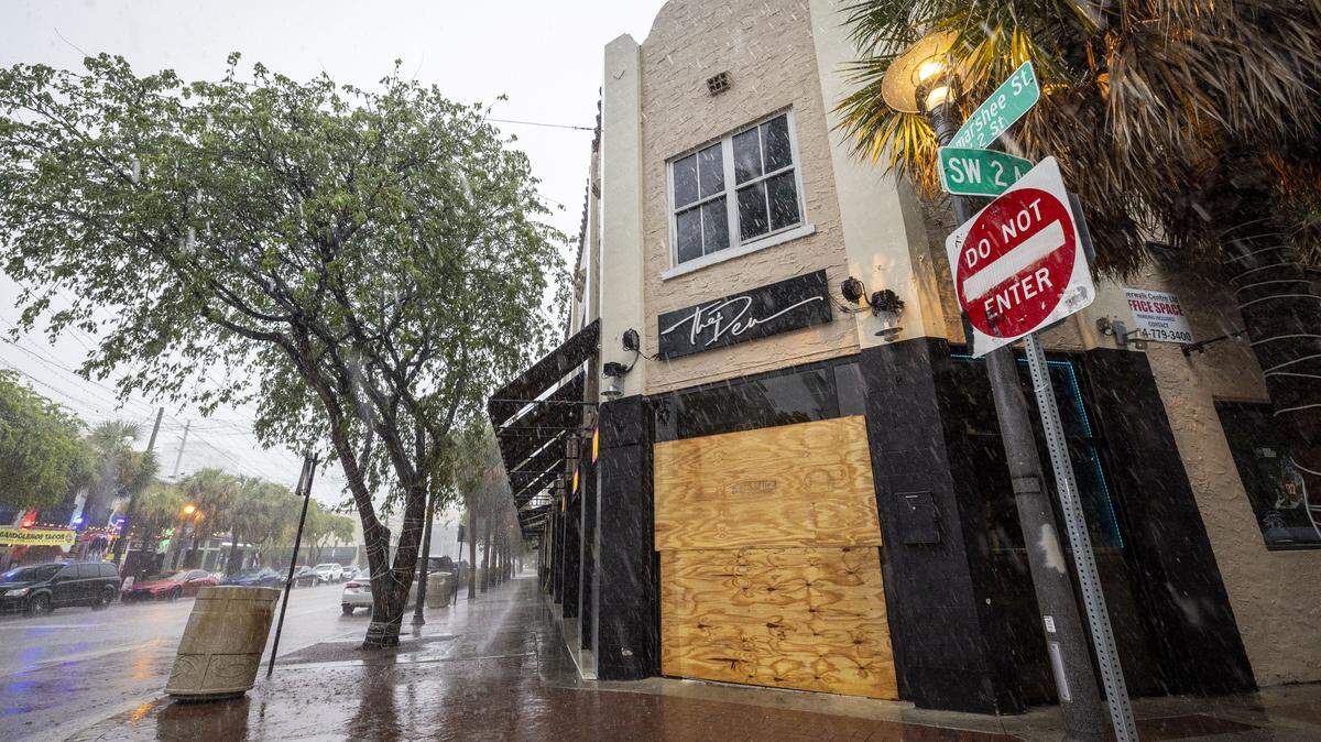 Fort Lauderdale, Florida, August 23, 2024 - Boarded up entrance of The Den Sports Bar and Lounge, located at 201 SW Second St., Fort Lauderdale police said a train struck the back of a pickup truck, and two other vehicles crashed into each other while trying to move off the tracks. One car was pushed onto the sidewalk and into the front doors of The Den Sports Bar and Lounge, located at 201 SW Second St., striking a woman outside.