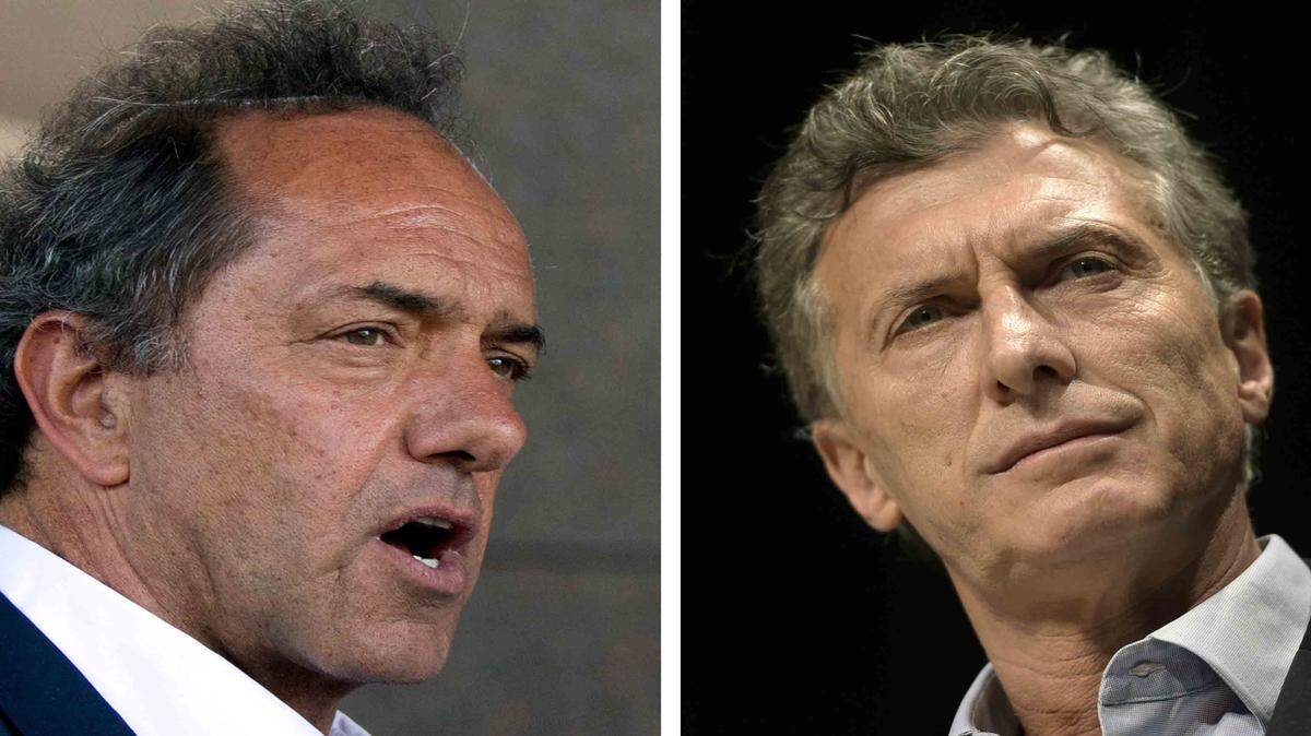 De izquierda a derecha, el candidato oficialista Daniel Scioli y el opositor Mauricio Macri.