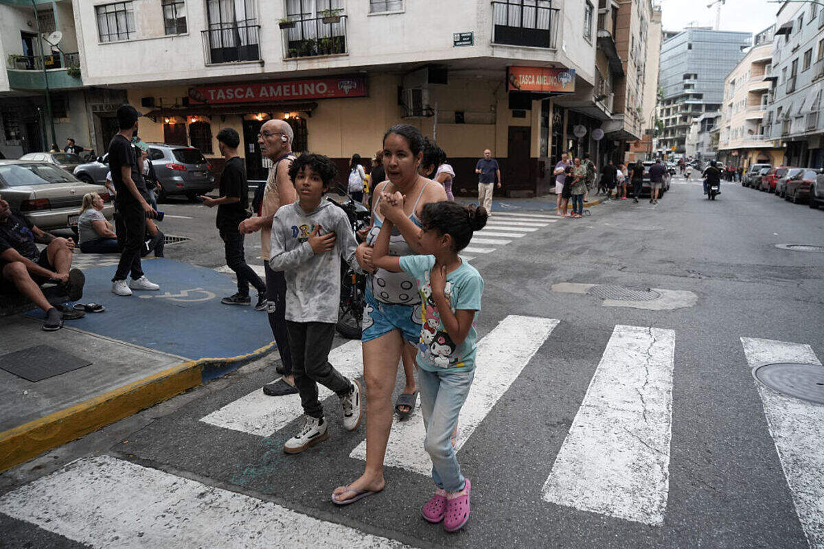 People remain on a street following an earthquake in Caracas on June 24, 2026. A magnitude 7.1 earthquake struck Venezuela on Wednesday, the United States Geological Survey (USGS) reported, triggering panic in Caracas, according to AFP journalists. The tremor, which was followed by several aftershocks, was also felt in Colombia.\