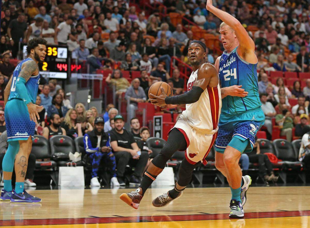 El jugador del Heat Jimmy Butler (22) entra al aro ante la marca de Mason Plumlee, de los Hornets de Charlotte, en el partido celebrado el 5 de abril de 2022 en Miami.