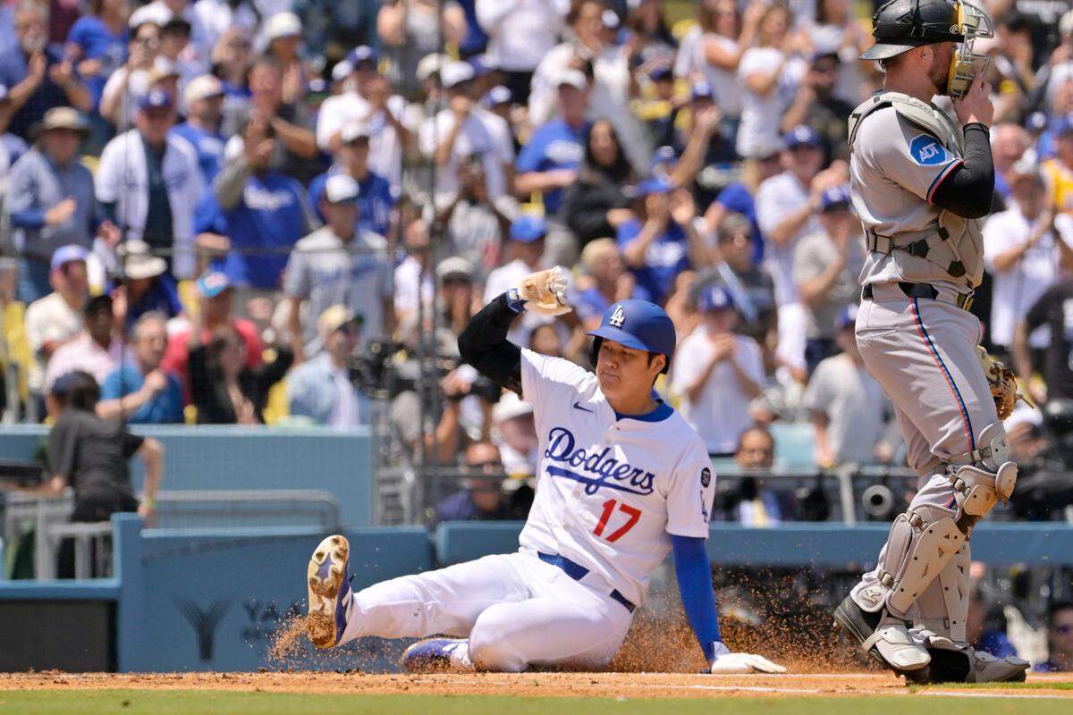 Apr 30, 2025; Los Angeles, California, USA; Los Angeles Dodgers designated hitter Shohei Ohtani (17) slides into home to score against the Miami Marlins during the third inning at Dodger Stadium. Mandatory Credit: Jayne Kamin-Oncea-Imagn Images