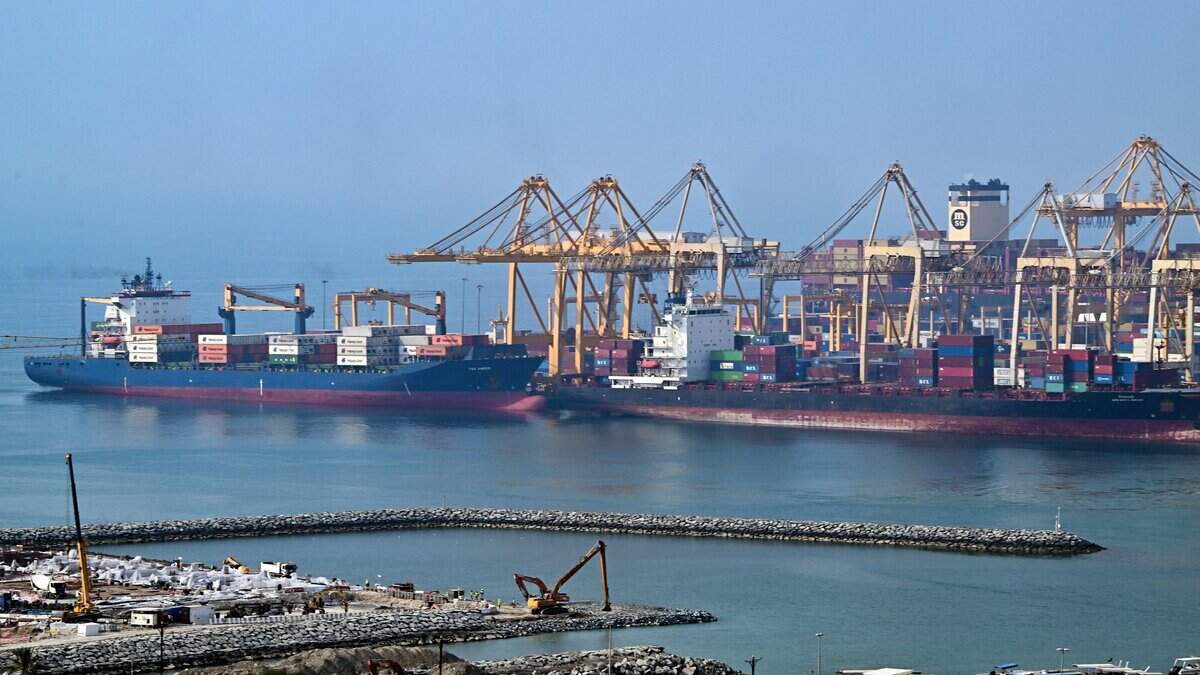 Ships are docked along a pier at the Khor Fakkan Container Terminal, the only natural deep-sea port in the region and one of the major container ports in Sharjah Emirate, along the Gulf of Oman on July 14, 2026. Tehran announced it was closing the Strait of Hormuz on July 12 and launched missiles and drones at its Gulf neighbours, in retaliation for new US strikes following an attack by Iranian forces on a merchant vessel that was abandoned in flames by its crew. (Photo by AFP via Getty Images) / 