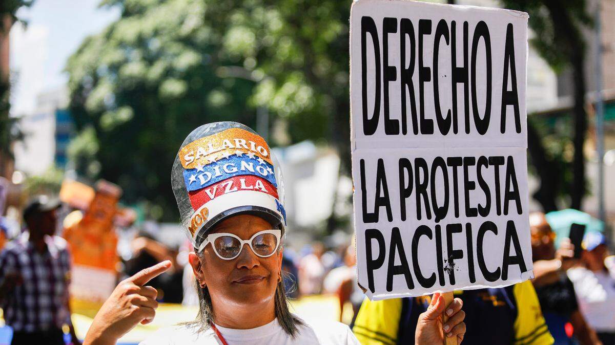 In May, woman takes part in a protest in Caracas, Venezuela, for higher salaries and pensions.