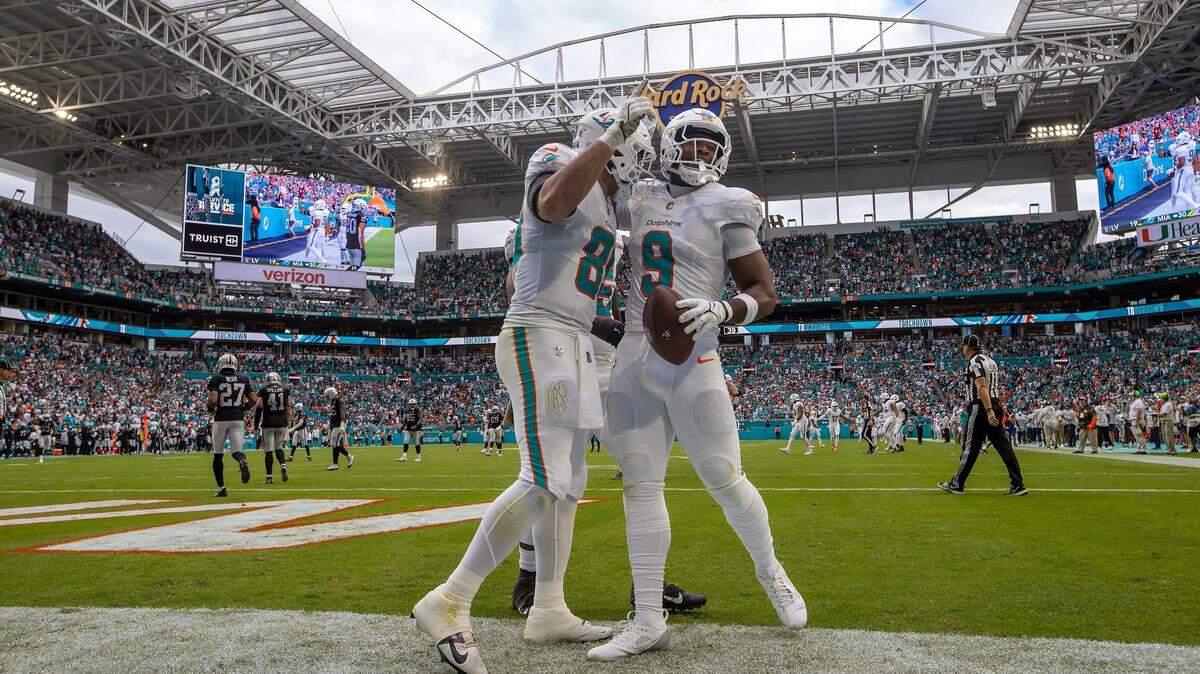 El tight end de los Dolphins Jonnu Smith (9) celebra con su compañero de equipo Julian Hill tras anotar un touchdown en el partido ante los Raiders de Las Vegas, celebrado el 17 de noviembre de 2024 en Miami Gardens, Florida.