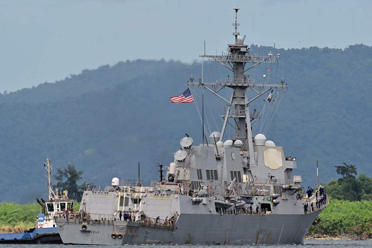 Tug boats assist as the USS Gravely warship docks in the port of Port of Spain on October 26, 2025. The US warship will visit Trinidad and Tobago for joint exercises near the coast of Venezuela amid Washington's campaign against alleged drug traffickers in the region. (Photo by Martin BERNETTI / AFP) (Photo by MARTIN BERNETTI/AFP via Getty Images)