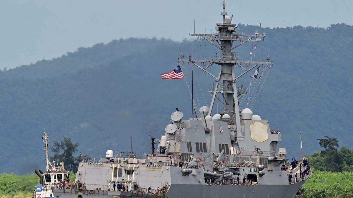 Tug boats assist as the USS Gravely warship docks in the port of Port of Spain on October 26, 2025. The US warship will visit Trinidad and Tobago for joint exercises near the coast of Venezuela amid Washington's campaign against alleged drug traffickers in the region. (Photo by Martin BERNETTI / AFP) (Photo by MARTIN BERNETTI/AFP via Getty Images)