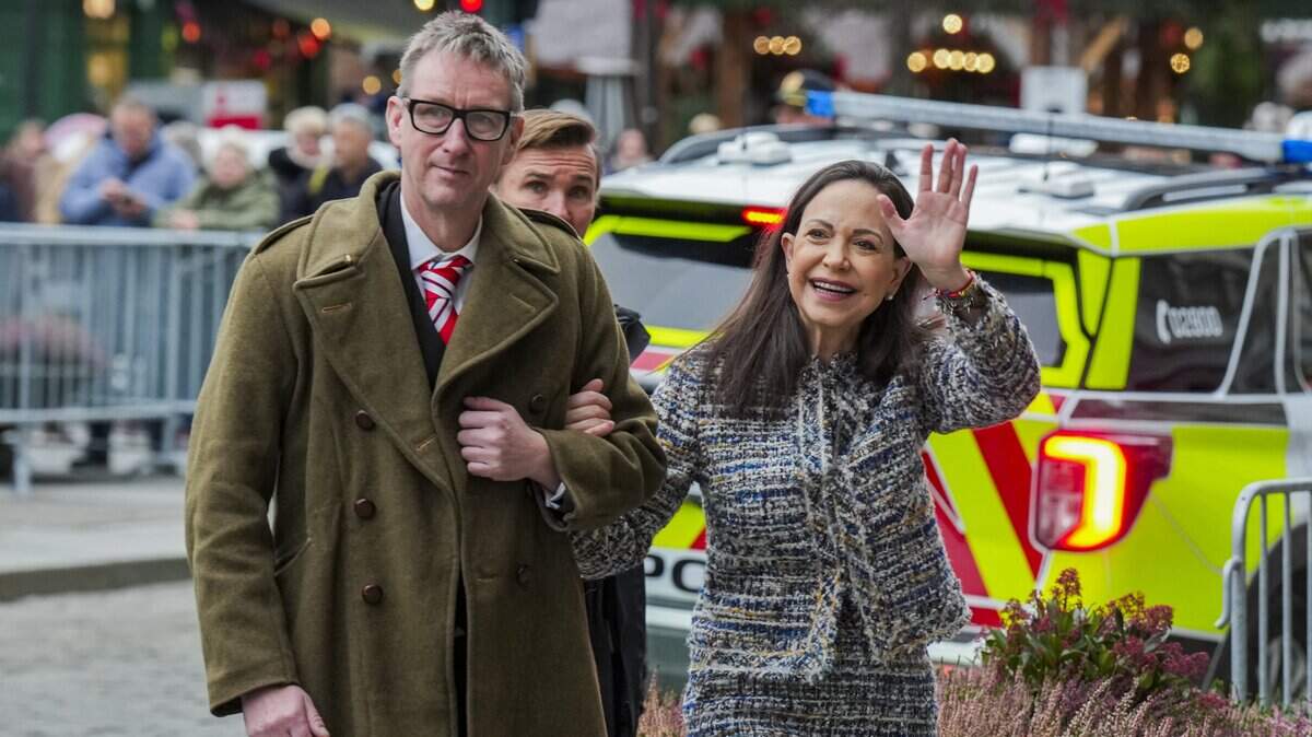 Nobel Peace Prize 2025 laureate Venezuelan opposition leader Maria Corina Machado (R) arrives with the Deputy Leader of the Norwegian Nobel Committee Asle Toje in front of the Grand Hotel in Oslo, Norway, after an audience at the Royal Palace. Machado -- who vanished in January 2025 after challenging the rule of Venezuelan President Nicolas Maduro -- won the 2025 Peace Prize for "her struggle to achieve a just and peaceful transition from dictatorship to democracy". (Photo by Ole Berg-Rusten / NTB / AFP via Getty Images) / Norway OUT