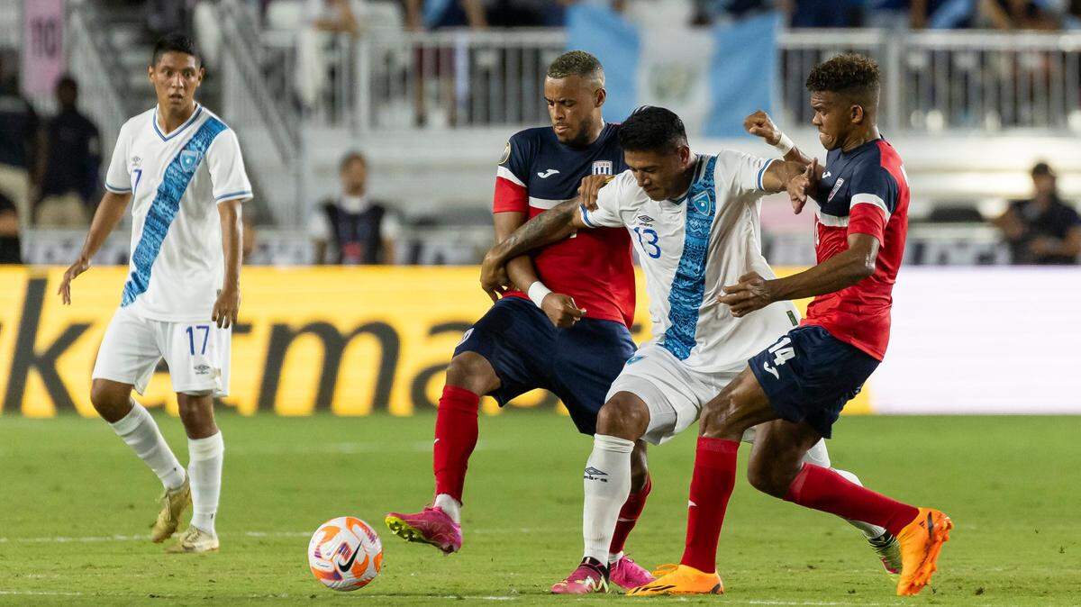 Guatemala midfielder Alejandro Galindo (13) fights for possession of the ball against Cuba midfielder Neisser Sandó (14) and defender Modesto Méndez (2) in the first half of their CONCACAF Gold Cup 2023 match at DRV PNK Stadium on Tuesday, June 27, 2023, in Fort Lauderdale, Fla.
