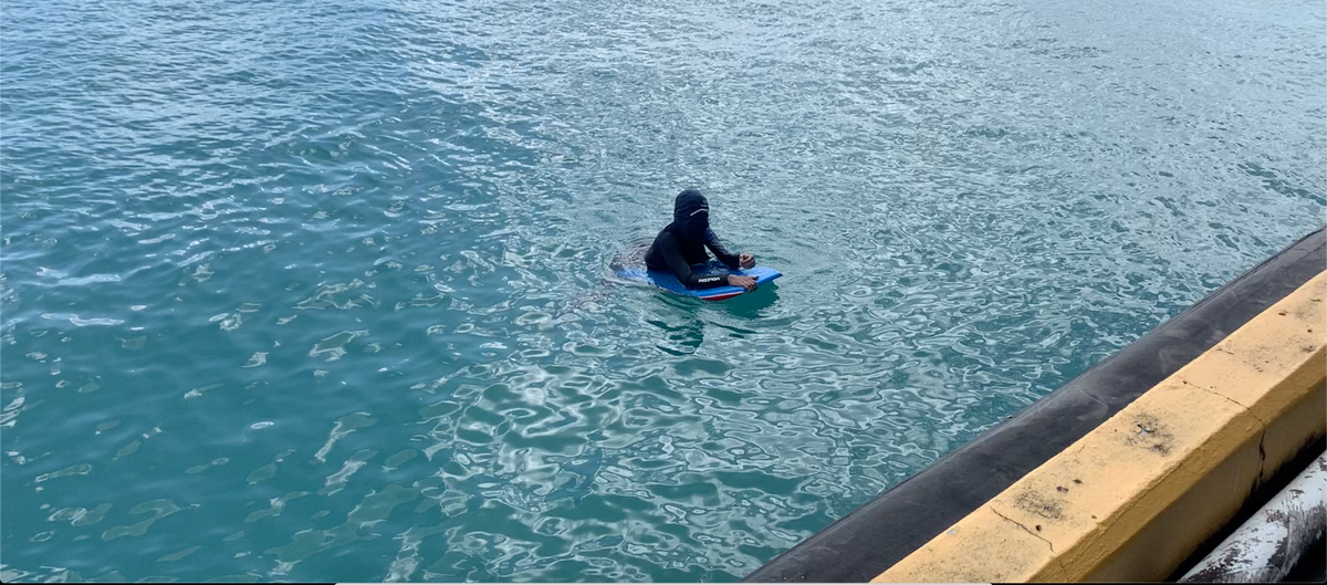 An aquatic protester blocks a passenger ferry from entering Vieques on March 10, 2020.
