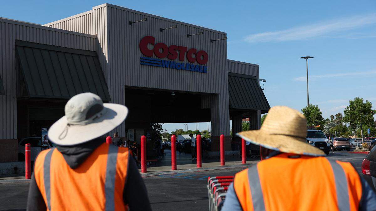 Employees push shopping carts outside a Costco Wholesale warehouse store in Hawthorne, California, on August 27, 2025. (Photo by Patrick T. Fallon / AFP) (Photo by PATRICK T. FALLON/AFP via Getty Images)