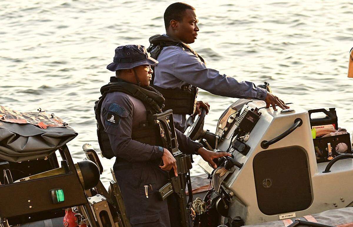 A Trinidad and Tobago Coast Guard patrol secures the area surrounding the USS Gravely, docked at Port of Spain on October 27, 2025. Trinidad and Tobago Prime Minister Kamla Persad-Bissessar on Monday rejected a threat by neighboring Venezuela to pull the plug on a joint gas project over her government's hosting of an American warship. (Photo by MARTIN BERNETTI / AFP) (Photo by MARTIN BERNETTI/AFP via Getty Images)
