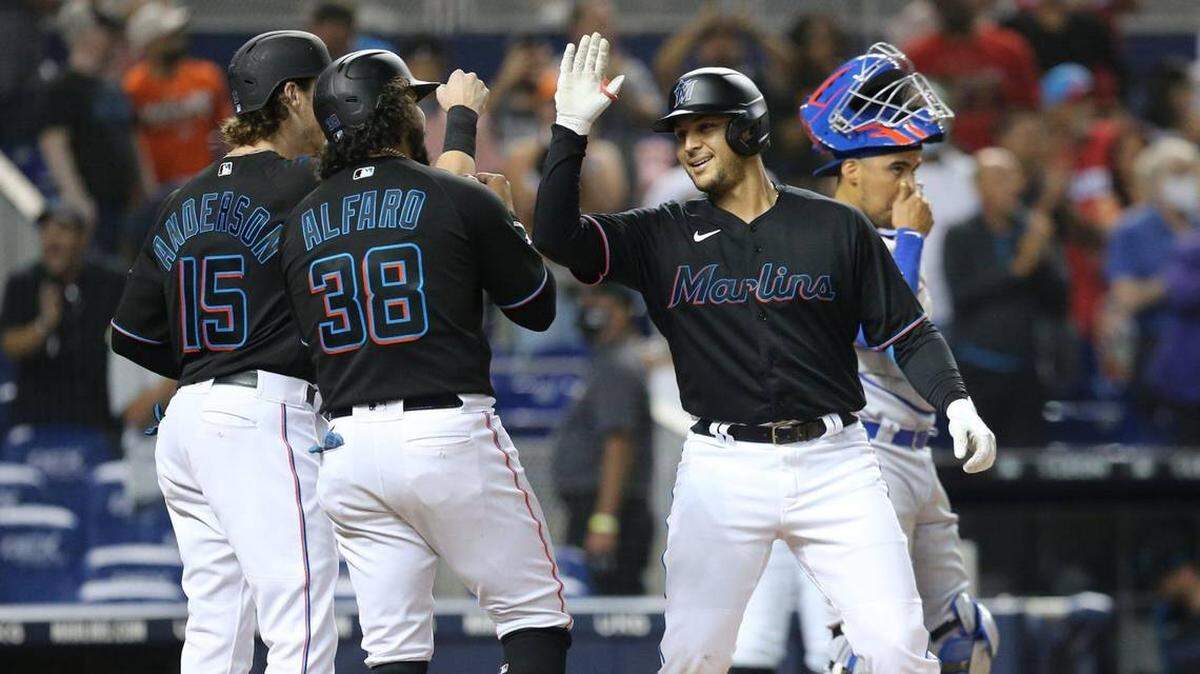 El receptor Alex Jackson (23) celebra tras pisar la goma con Brian Anderson (15) y Jorge Alfaro (38), después de pegar un cuadrangular de tres carreras en la segunda entrada contra los Cachorros el 13 de agosto del 2021.