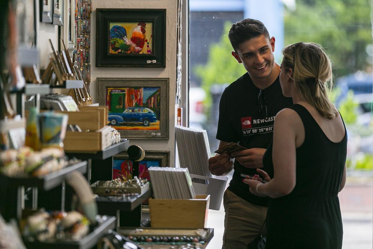 Shaun Henderson, 23, and Lidia Dixon, 24, both tourists from England, shop for souvenirs at the RC Gallery in Little Havana on Tuesday, September 11, 2019.