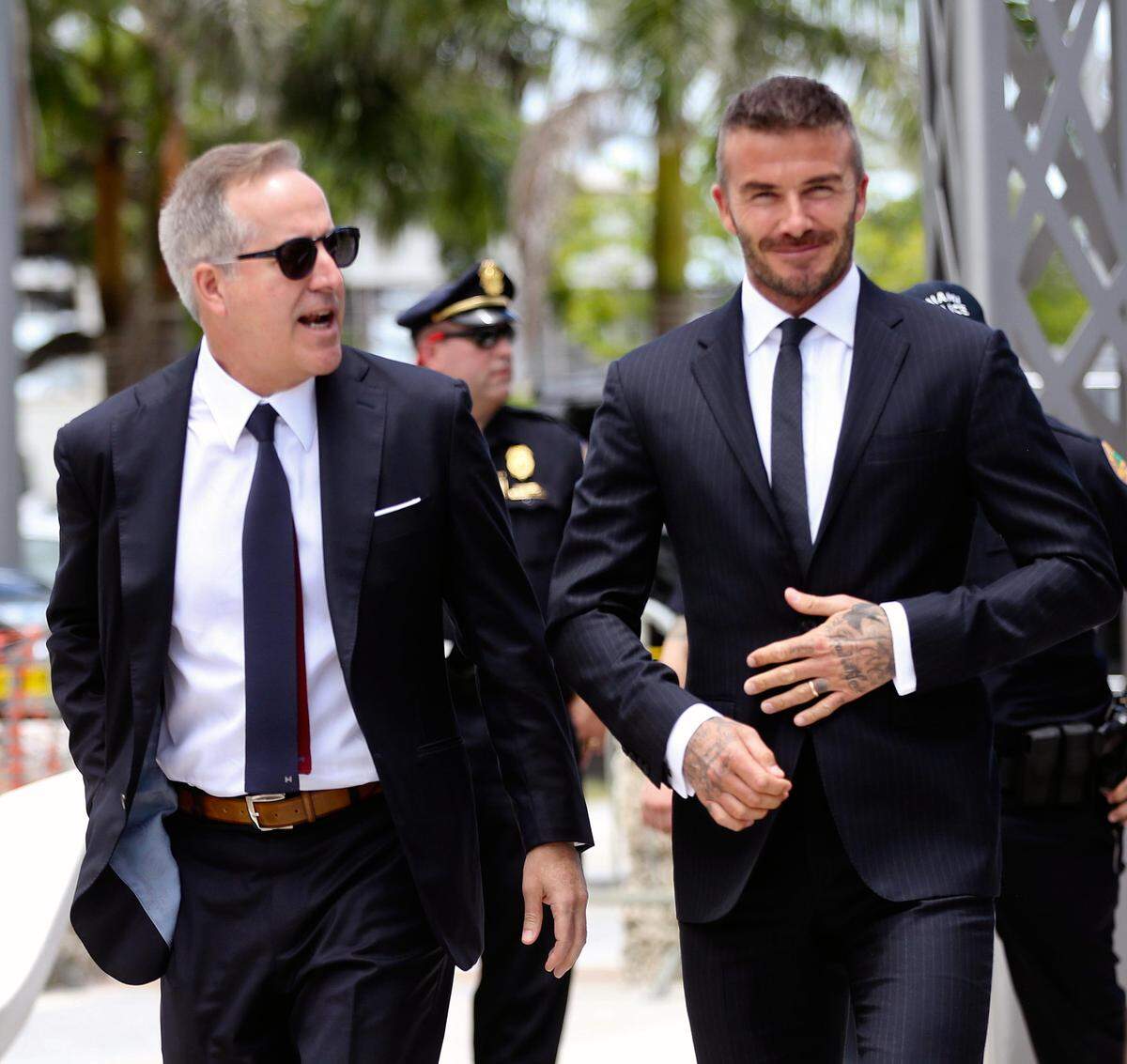 Jorge Mas, left, and David Beckham on their way to make their case before the Miami City Commission in July.