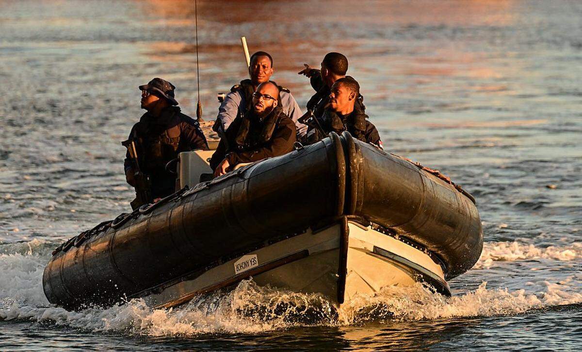 A Trinidad and Tobago Coast Guard patrol secures the area surrounding the USS Gravely, docked at Port of Spain on October 27, 2025. Trinidad and Tobago Prime Minister Kamla Persad-Bissessar on Monday rejected a threat by neighboring Venezuela to pull the plug on a joint gas project over her government's hosting of an American warship. (Photo by MARTIN BERNETTI / AFP) (Photo by MARTIN BERNETTI/AFP via Getty Images)
