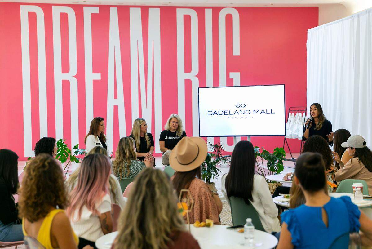 Brittany Valdes, far-right with microphone, the founder of The Mom Economy, speaks during SHOP MOM hosted by The Mom Economy and Shopify inside Dadeland Mall in Miami’s Kendall neighborhood on Friday, November 5, 2021.
