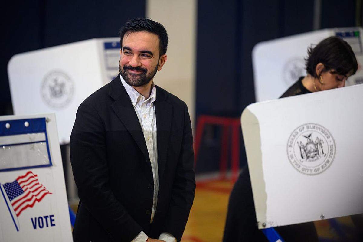 NEW YORK, NEW YORK - NOVEMBER 04: Democratic Mayoral Candidate Zohran Mamdani reacts as his wife, Rama Duwaji, votes at The Frank Sinatra School of the Arts on November 04, 2025 in the Queens borough of New York City. Voters in NYC are voting for who will be replacing Mayor Eric Adams between the front runner New York Mayoral Candidate Zohran Mamdani and New York City mayoral candidate Andrew Cuomo and Republican mayoral candidate Curtis Sliwa. More than 735,000 people have voted early, according to the Board of Elections, more than four times as many as in the 2021 contest. This election also has other city offices on the ballot, as well as six proposals. (Photo by Alexi J. Rosenfeld/Getty Images)