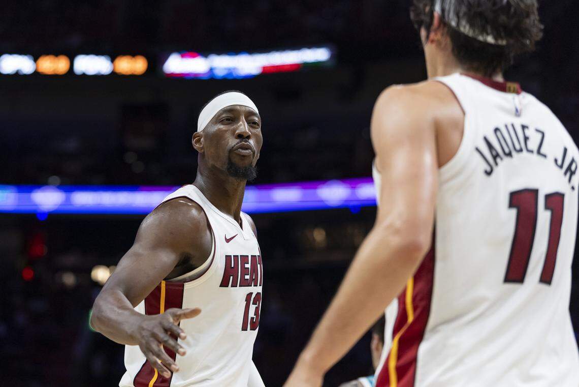 Miami Heat center Bam Adebayo (13) and guard Jaime Jaquez Jr. (11) react after a play against the Charlotte Hornets in the first half of their NBA game at Kaseya Center on Oct. 28, 2025, in Miami.