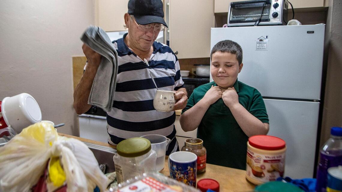 He and his father live in an unfurnished apartment. What he needs most is a computer