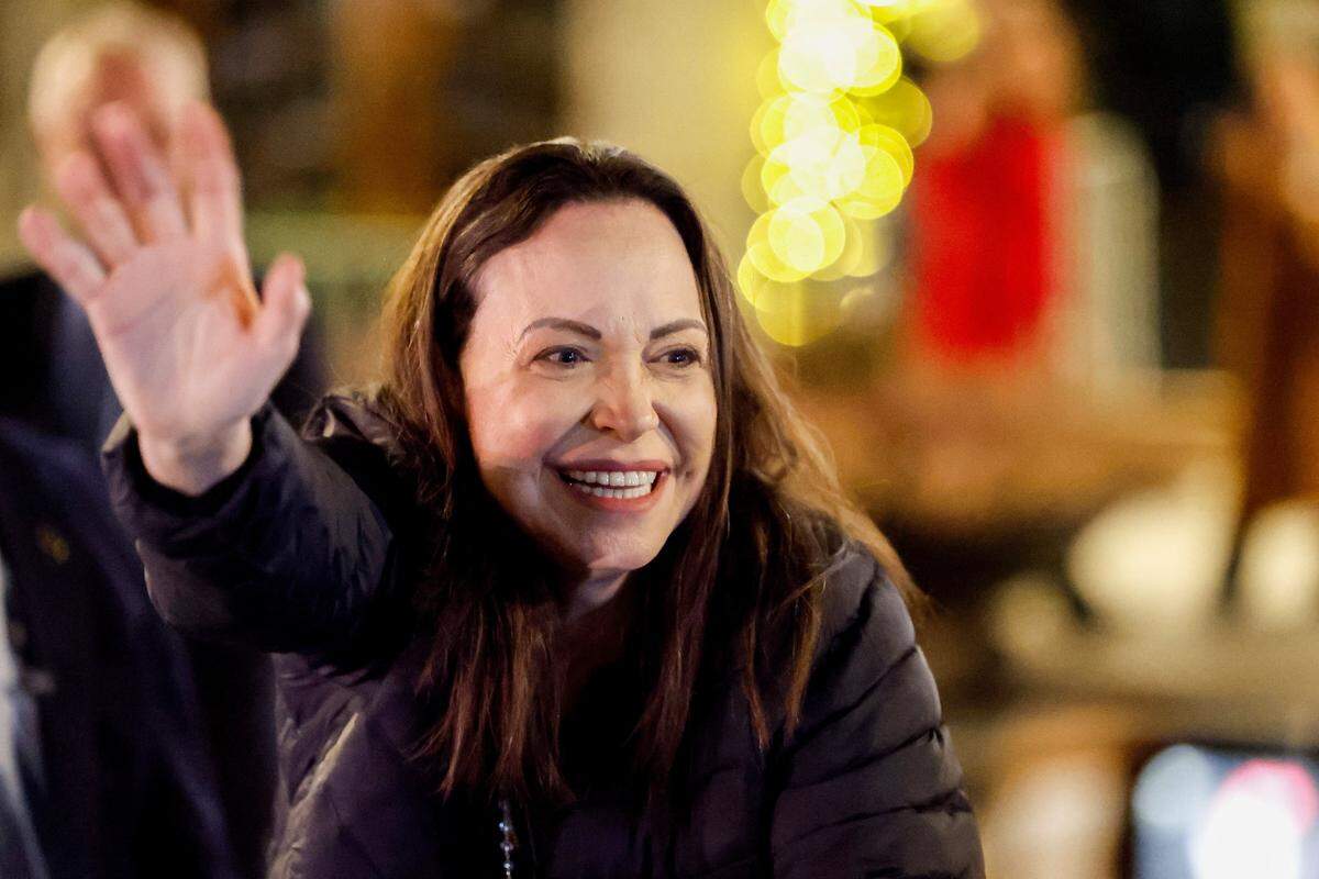 Nobel peace laureate Maria Corina Machado greets supporters gathered outside the Grand Hotel in Oslo, Norway, early on December 11, 2025. Machado arrived in Oslo hours after the Venezuelan opposition leader's award was collected on her behalf by her daughter. (Photo by Jonas Been Henriksen / NTB / AFP via Getty Images) / Norway OUT