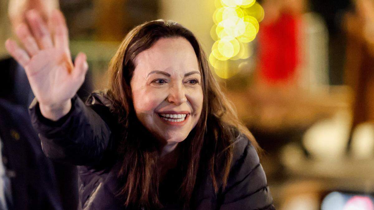 Nobel peace laureate Maria Corina Machado greets supporters gathered outside the Grand Hotel in Oslo, Norway, early on December 11, 2025. Machado arrived in Oslo hours after the Venezuelan opposition leader's award was collected on her behalf by her daughter. (Photo by Jonas Been Henriksen / NTB / AFP via Getty Images) / Norway OUT