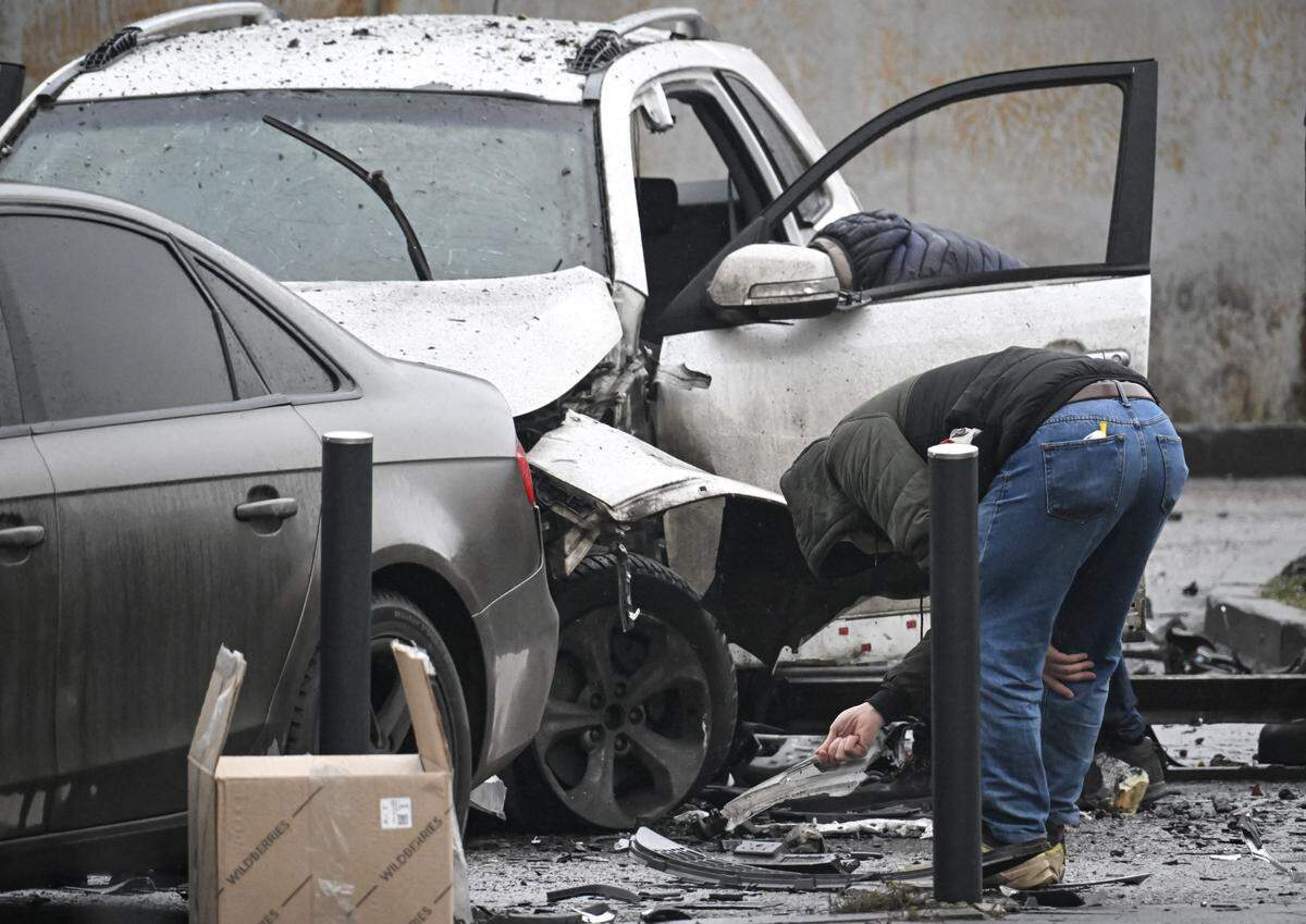 Investigators work at the car blast site in southern Moscow on December 22, 2025. Lieutenant General Fanil Sarvarov, head of the training department within the General Staff, was killed in Moscow on December 22, 2025 after an explosive device placed under his car went off, investigators said in a statement. (Photo by Alexander NEMENOV / AFP via Getty Images)
