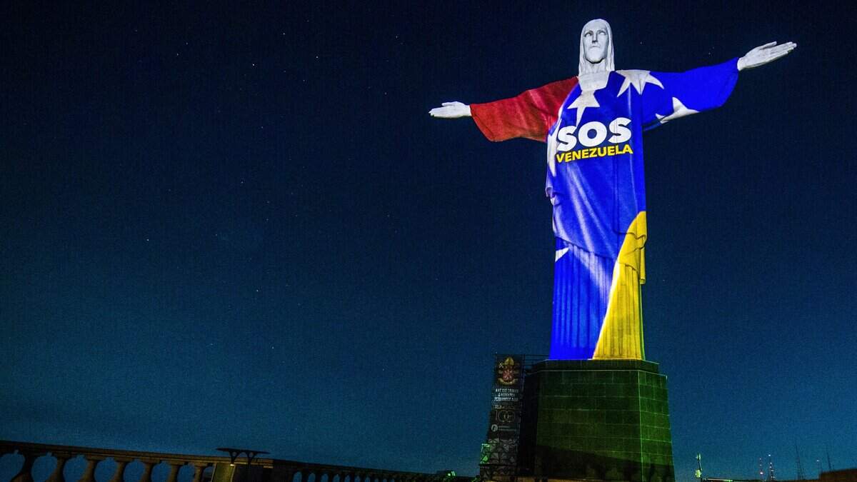 Christ the Redeemer monument is iluminated with the Venezuelan flag colors and reading SOS Venezuela, in solidarity with the victims of the deadly June 24 twin earthquakes, in Rio de Janeiro, Brazil, on July 2, 2026. (Photo by Daniel RAMALHO / AFP via Getty Images)