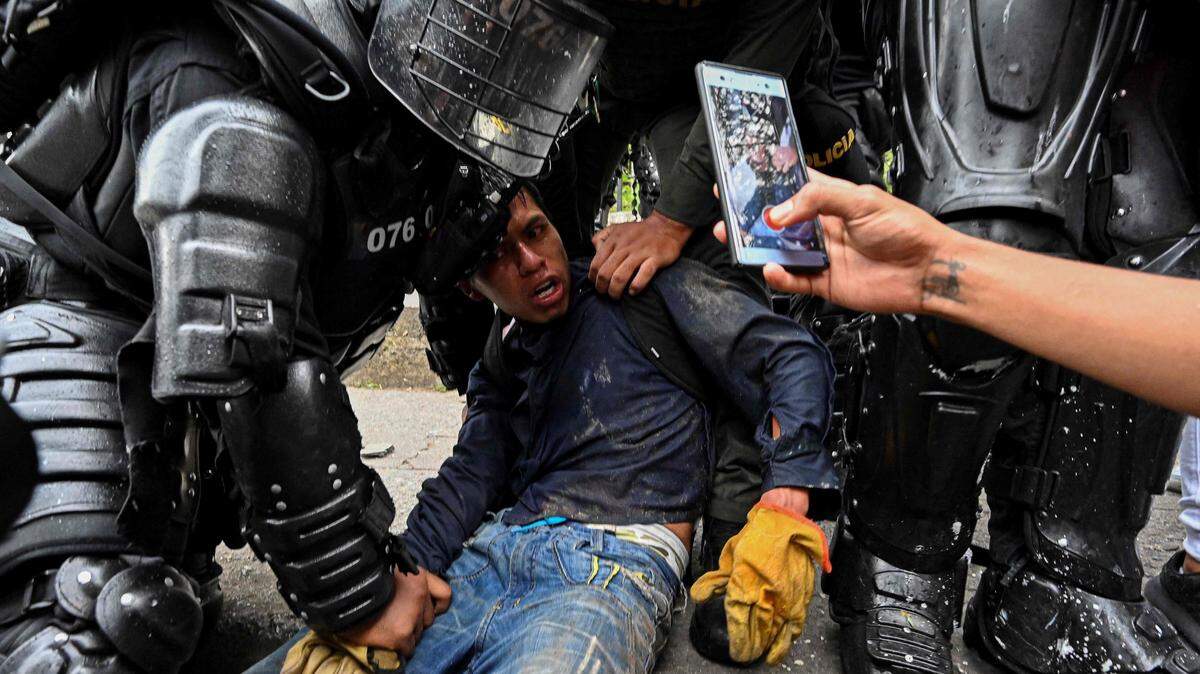 Colombian police officers arrest a demonstrator during a protest against the government in Cali, Colombia, on May 10, 2021.
