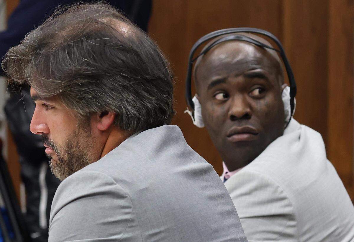 Adolfo Gil, a la izquierda, sentado con su cliente Yosvanis (Chocolate MC) Sierra Hernández mientras la fiscalía presentaba a su testigo durante el primer día de su juicio por instigación al homicidio el miércoles 12 de noviembre de 2025, en Miami, Florida.