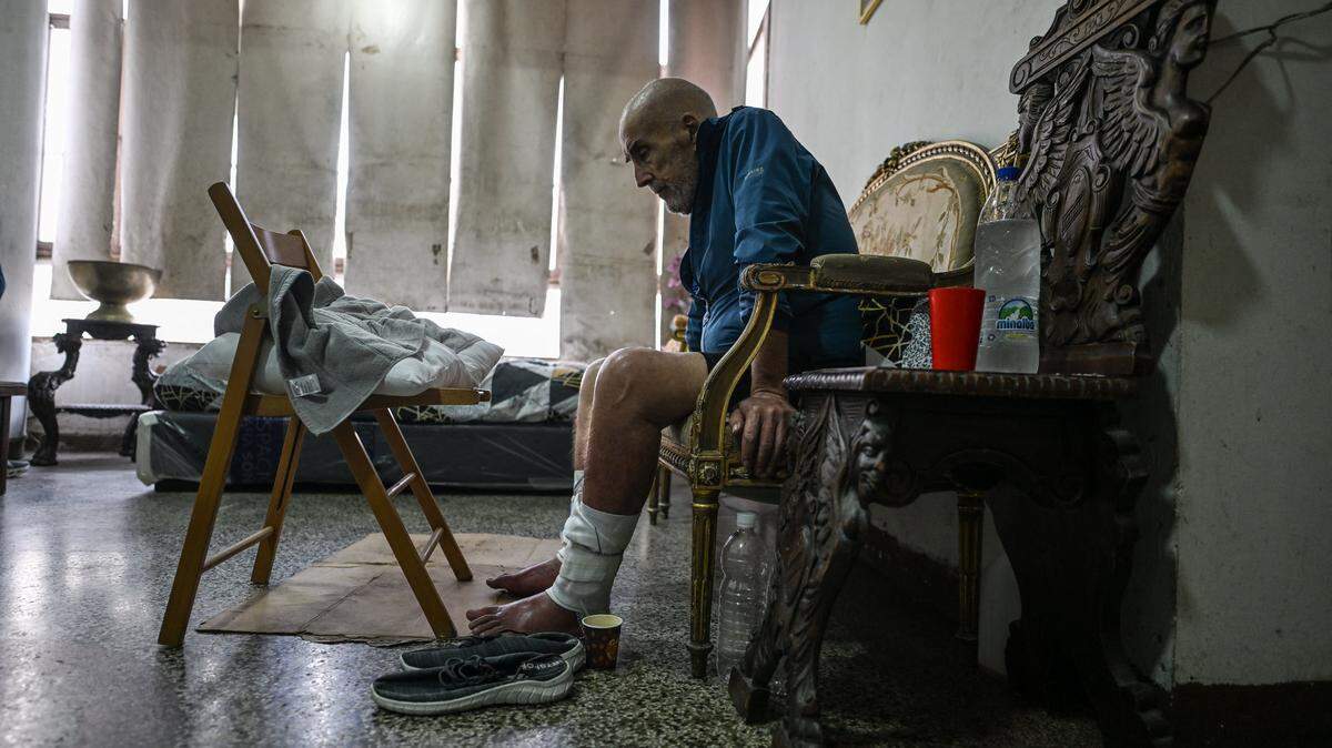 Venezuelan-Uruguayan citizen Jose Breijo, 70, sits inside his apartment in Caracas on May 27, 2026. At the age of 70, José Breijo was released from prison as part of an amnesty for political prisoners in Venezuela. When he returned to his apartment, he found it filled with the belongings of the police officer who had arrested him. He was then forced to sleep in the hallways outside before he could reclaim his home. (Photo by Juan BARRETO / AFP via Getty Images)