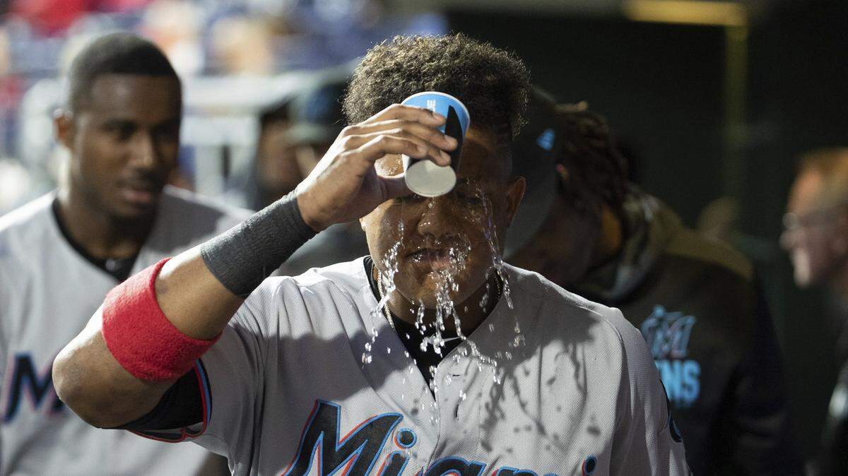 Miami Marlins second baseman Starlin Castro, seen here pouring water on his head in the visitor’s dugout at Citizens Bank Park, has recorded multiple hits in four of his last six games.