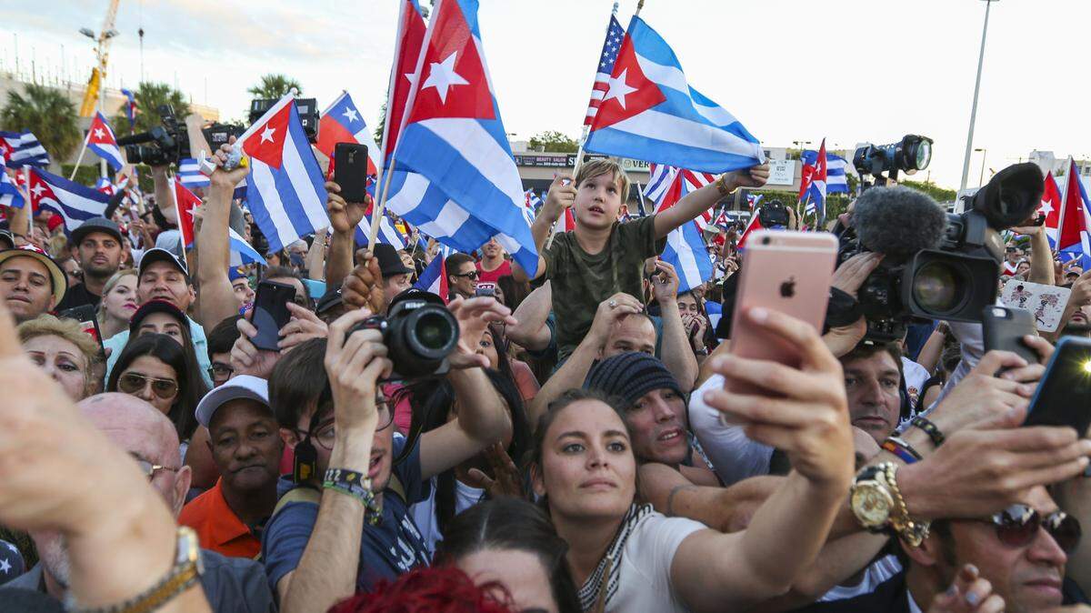 A large crowd reacts after Cuban musician Willy Chirino arrives at the Versailles Restaurant in Little Havana on Nov. 26, 2016, following the announcement of former Cuban leader Fidel Castro’s death.