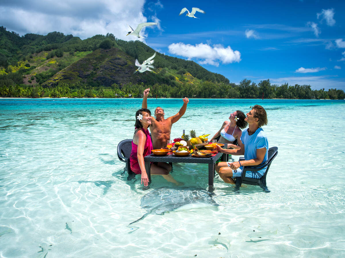 Turistas en las aguas paradisíacas de Moorea, una isla volcánica y está a solo 30 kilómetros de la capital. Entre sus joyas encontramos una de las lagunas más bellas del país en la que se puede hacer snorkel y buceo.
