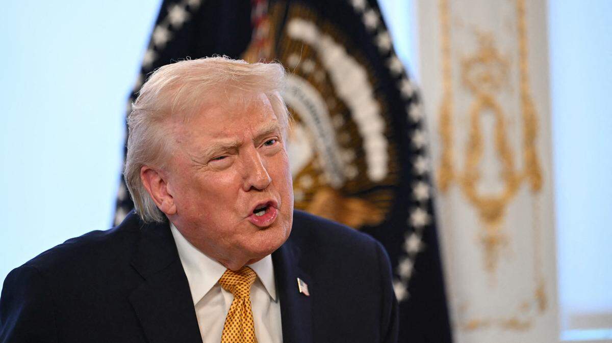 US President Donald Trump participates in calls to US service members, on Christmas Eve, from the Mar-a-Lago club in Palm Beach, Florida, December 24, 2025. (Photo by ANDREW CABALLERO-REYNOLDS / AFP via Getty Images)