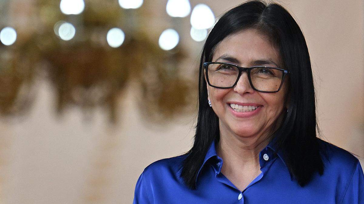 Venezuela's interim President Delcy Rodriguez smiles during  a press conference at the Miraflores Presidential Palace in Caracas on January 14, 2026. Venezuela's interim president Delcy Rodriguez said on January 14, that her country was looking to "a new political era" after the January 3 ouster of leader Nicolas Maduro in a US military strike. (Photo by Juan BARRETO / AFP via Getty Images)
