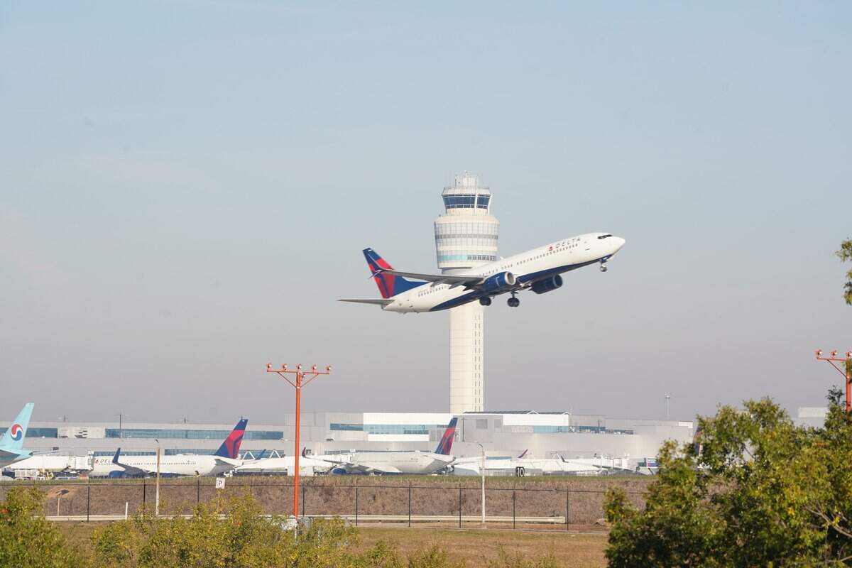 ATLANTA, GEORGIA - NOVEMBER 7: A plane flies past the air traffic control tower as people travel through Hartsfield-Jackson Atlanta International Airport on November 7, 2025 in Atlanta, Georgia. Today marks day 38 of the government shutdown. (Photo by Megan Varner/Getty Images)