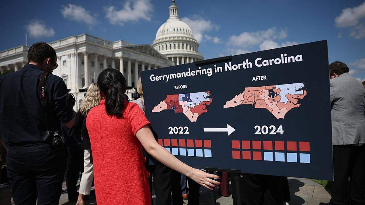 WASHINGTON, DC - SEPTEMBER 18: A staff members holds a chart showing the redistricting that has taken place in the state of North Carolina as members of Congress speak during a press conference outside the U.S. Capitol September 18, 2025 in Washington, DC. Democratic members of the House and Senate announced the introduction of bicameral legislation attempting to stop Republican efforts to redraw congressional districts in their favor before the upcoming midterm elections scheduled for 2026. (Photo by Win McNamee/Getty Images)
