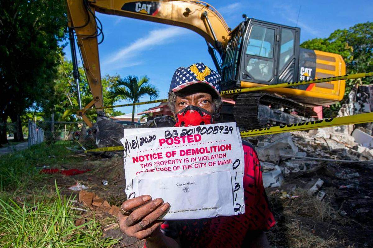Michael Hamilton shows the notice that was posted to his door. The city then came and leveled the home without attempting to help him find housing assistance.