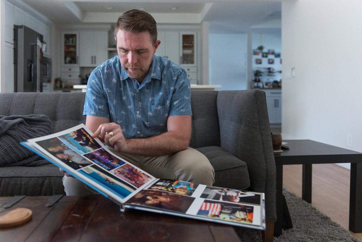 Lee Stonum mira un álbum de fotos de su hija. Stonum desearía haber podido obligar a su hija a vacunarse, pero sintió que su influencia era limitada porque ella no vivía con él a tiempo completo.