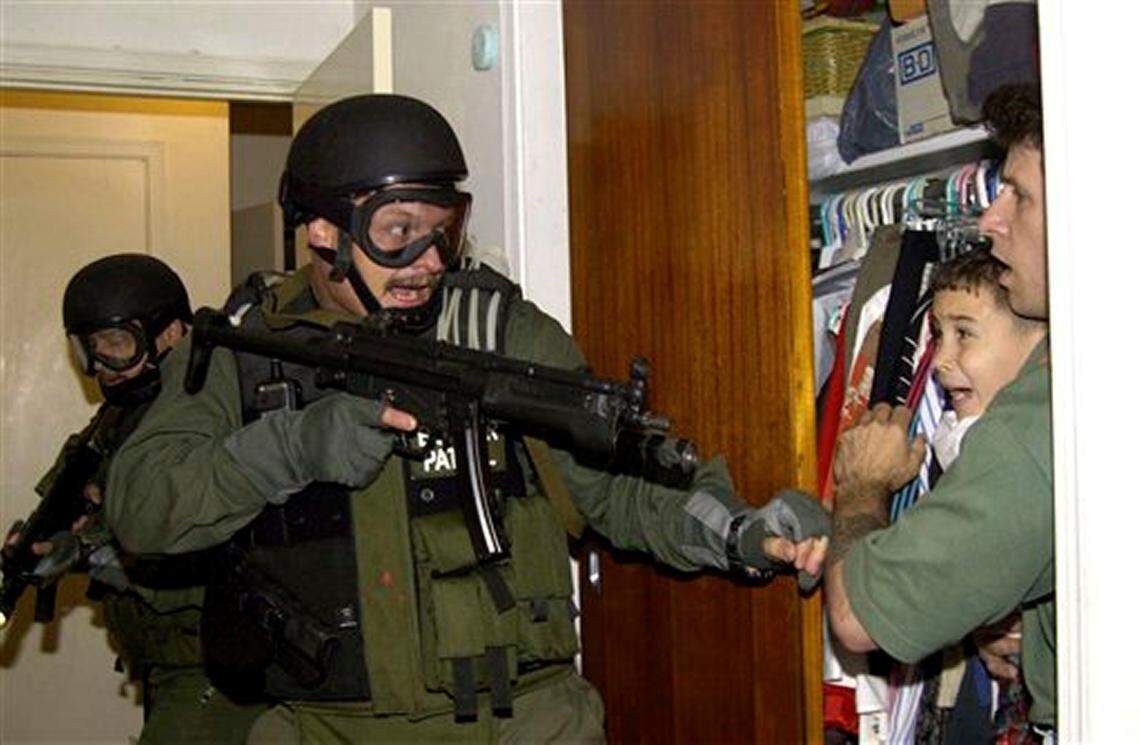 En la icónica foto tomada por Alan Díaz, Donato Dalrymple protege a Elián en un closet, de los agentes federales que registraban la casa de su familia en la Pequeña Habana, el 22 de abril del 2000.