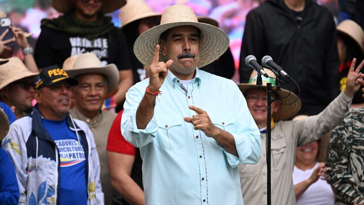 Venezuela's President Nicolas Maduro gestures during a rally to mark the anniversary of the Battle of Santa Ines, in Caracas on December 10, 2025. (Photo by Federico PARRA / AFP via Getty Images)