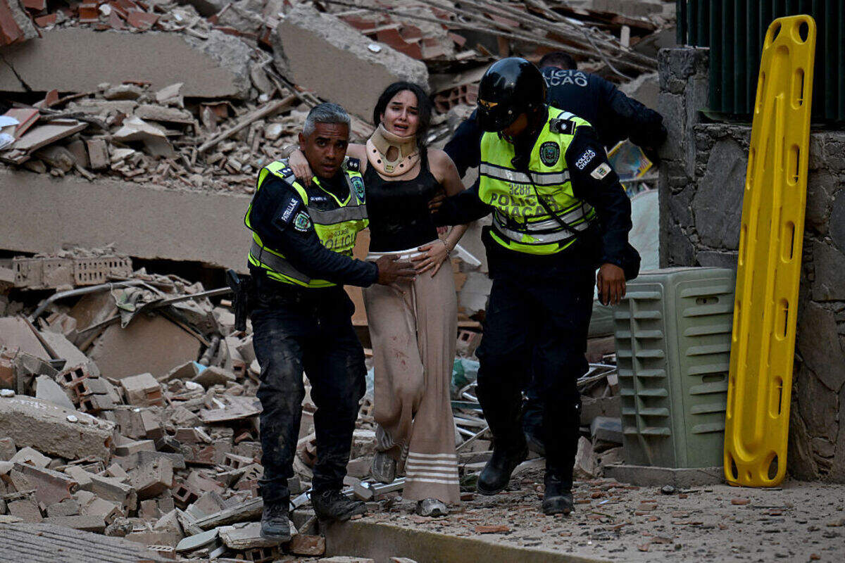 Municipal police officers evacuate an injured victim from a collapsed building following an earthquake in Caracas on June 24, 2026. A magnitude 7.1 earthquake struck Venezuela on Wednesday, the United States Geological Survey (USGS) reported, triggering panic in Caracas, according to AFP journalists. The tremor, which was followed by several aftershocks, was also felt in Colombia.